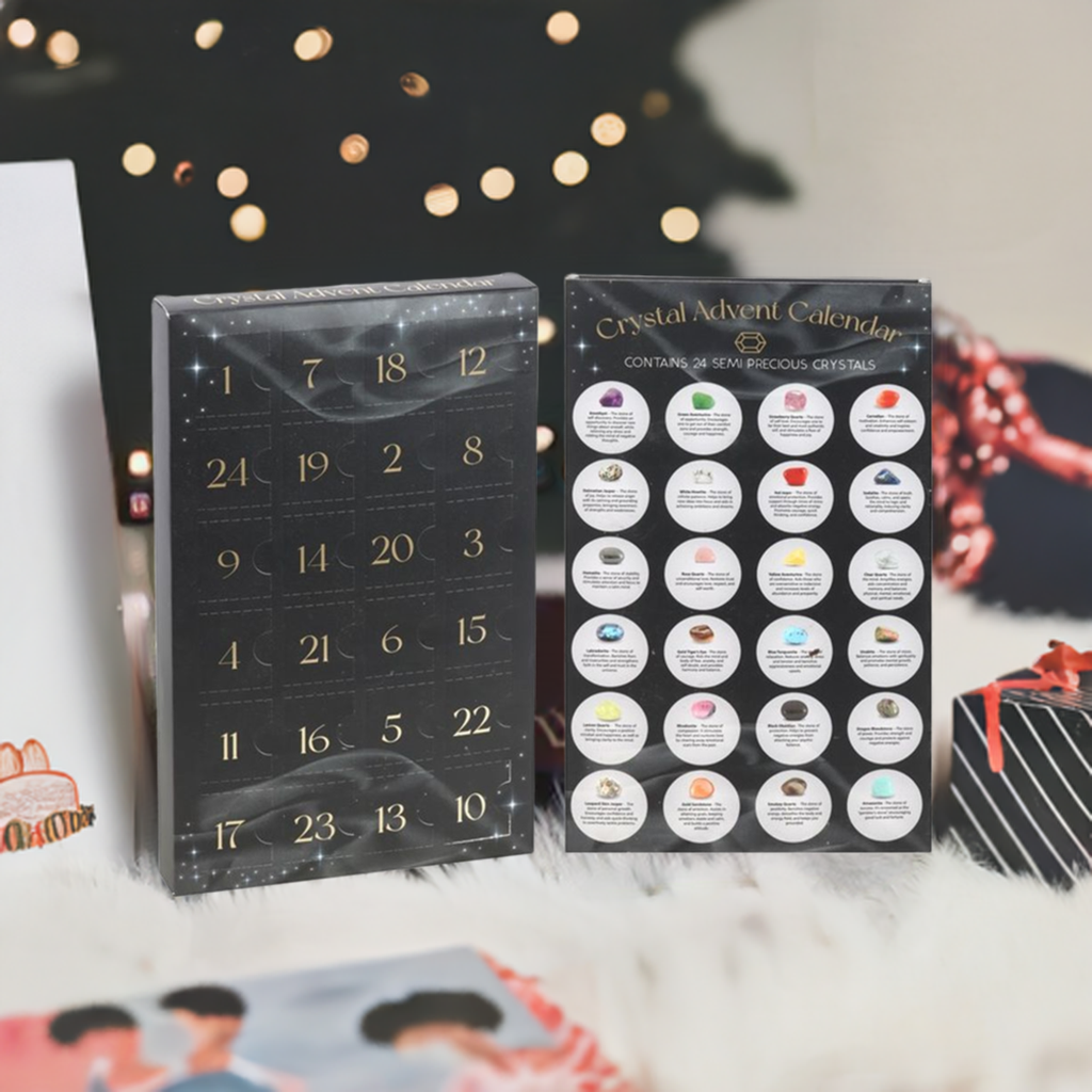 A black advent calendar box standing on white fur, Christmas tree in the background