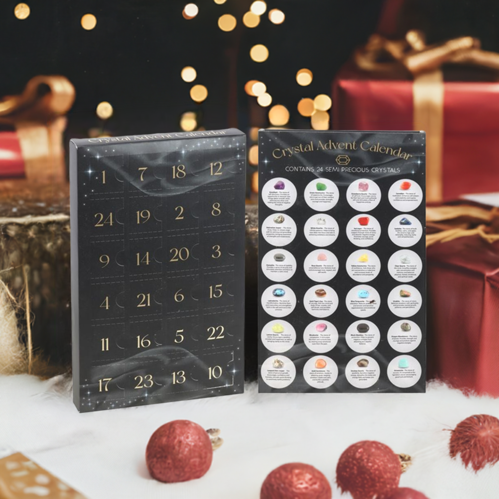 A black advent calendar box standing on white fur, red and golden gift boxes in the background