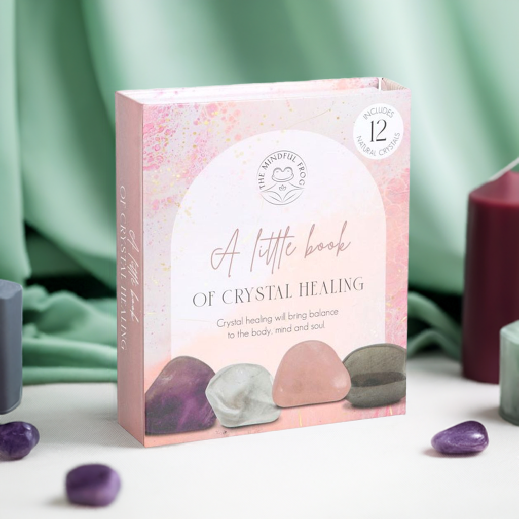 A pink pastel box with a green drape in the back ground, purple crystals around