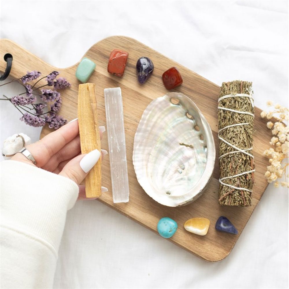 Divine Energy Smudge and Stone Wellness Kit, a holistic cleansing set featuring sustainably sourced sage smudge stick, palo santo, and healing crystals for energy purification, grounding, and spiritual balance. Perfect for meditation, chakra alignment, and clearing negative energy. Elevate your self-care rituals with this thoughtfully curated wellness kit.