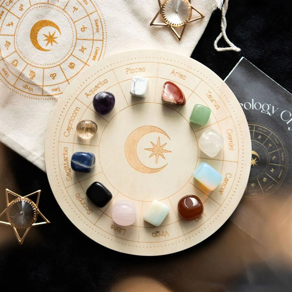 A wooden board with zodiac signs around and crystals related to astrology